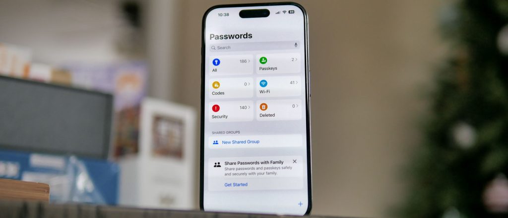 Apple Passwords app on an iPhone showing saved passwords, passkeys, verification codes, security alerts, and shared password groups.